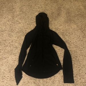 black lululemon wind breaker jacket with pockets, hood, and thumb holes